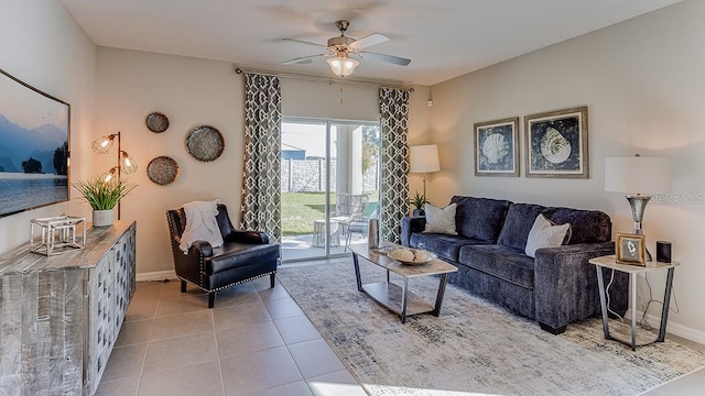 living room featuring tile patterned flooring, baseboards, and a ceiling fan