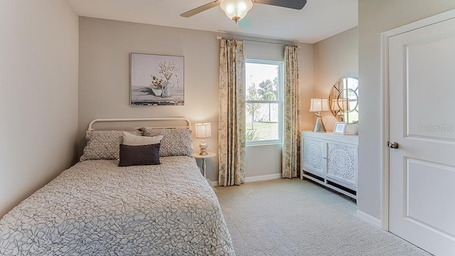 carpeted bedroom featuring ceiling fan and baseboards