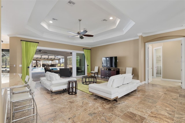 living area featuring a raised ceiling, visible vents, crown molding, and baseboards