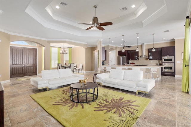 living room featuring visible vents and a raised ceiling