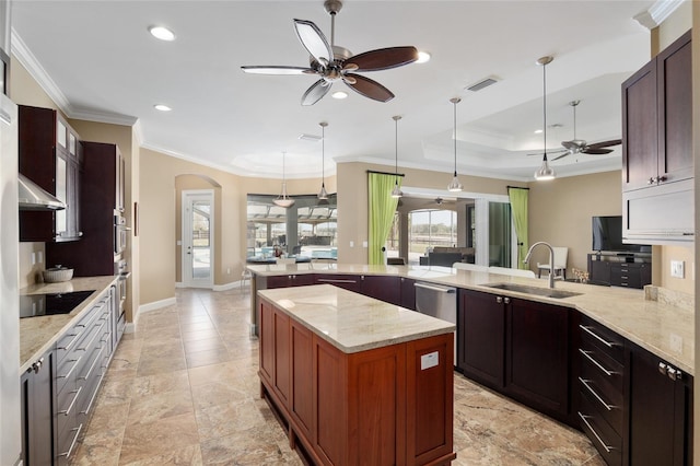 kitchen featuring visible vents, arched walkways, black electric stovetop, pendant lighting, and a sink