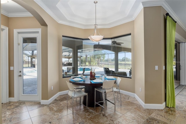 dining area with a sunroom, baseboards, and ornamental molding