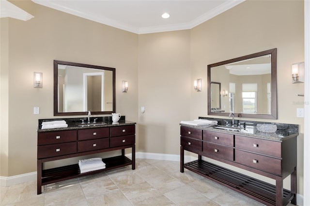 bathroom featuring ornamental molding, two vanities, and baseboards