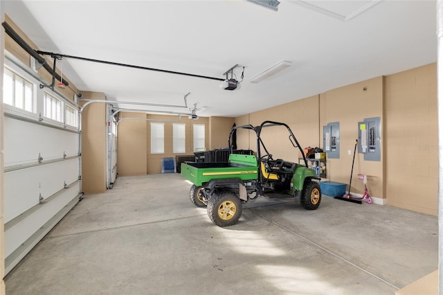 garage featuring electric panel and a garage door opener