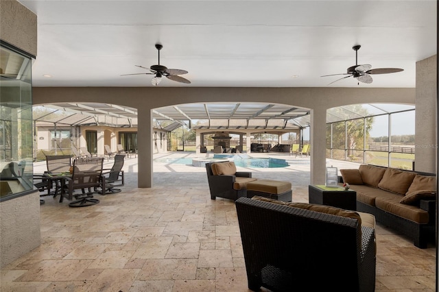 view of patio featuring an outdoor pool, glass enclosure, outdoor lounge area, and a ceiling fan