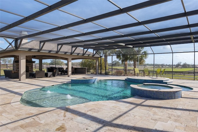 view of pool with a pool with connected hot tub, glass enclosure, and a patio