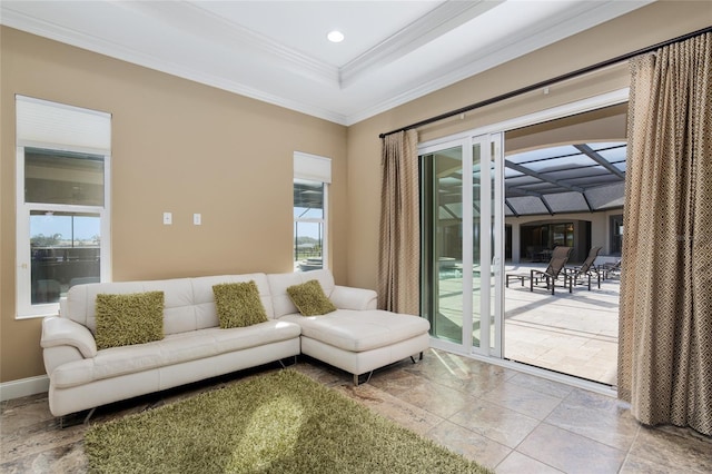 living room featuring ornamental molding, a tray ceiling, baseboards, and recessed lighting