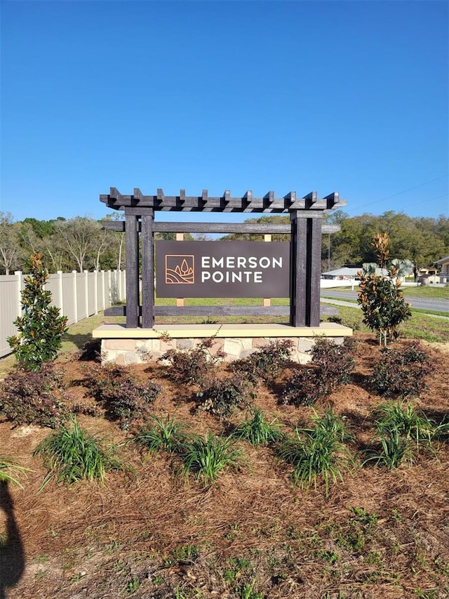 community sign featuring fence