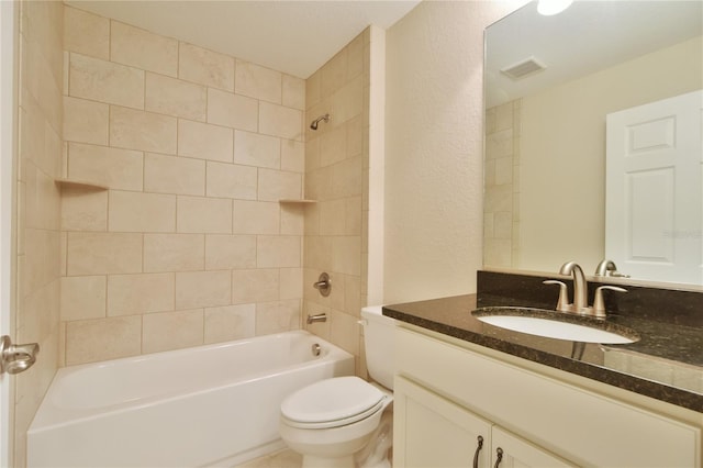 full bath with a textured wall, toilet, vanity, visible vents, and shower / washtub combination