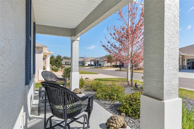 view of patio with covered porch and a residential view