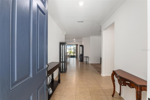 hall featuring light tile patterned floors, visible vents, baseboards, ornamental molding, and recessed lighting