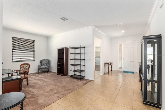 sitting room featuring ornamental molding, light colored carpet, visible vents, and light tile patterned flooring