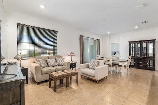 living room featuring light tile patterned floors, ornamental molding, visible vents, and recessed lighting