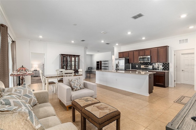 living room featuring light tile patterned floors, ornamental molding, visible vents, and recessed lighting