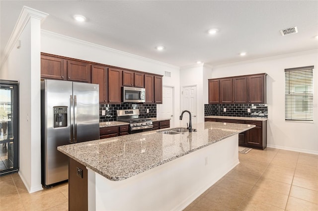 kitchen with stainless steel appliances, ornamental molding, a sink, and visible vents