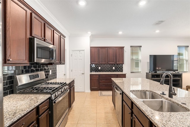 kitchen featuring light tile patterned floors, visible vents, appliances with stainless steel finishes, crown molding, and a sink