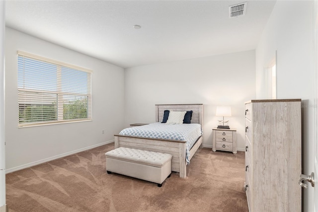 carpeted bedroom featuring visible vents and baseboards