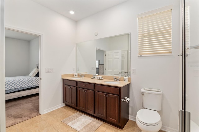 ensuite bathroom featuring double vanity, toilet, a sink, ensuite bath, and baseboards