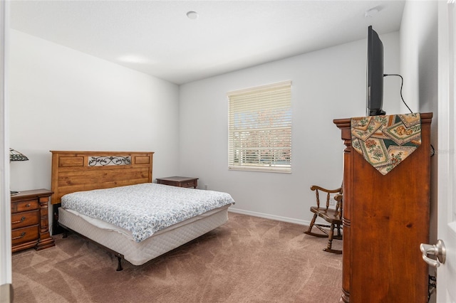 bedroom with carpet and baseboards