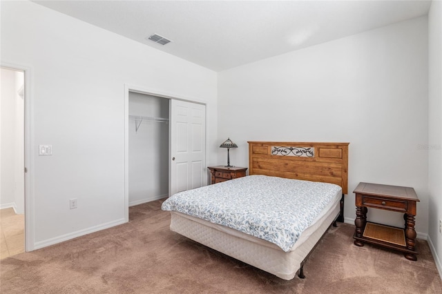 bedroom with carpet floors, a closet, visible vents, and baseboards