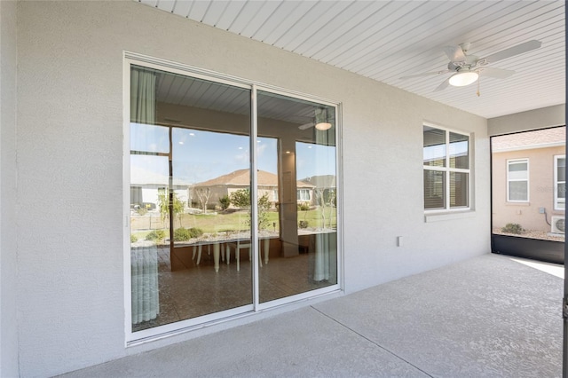 unfurnished sunroom featuring ceiling fan