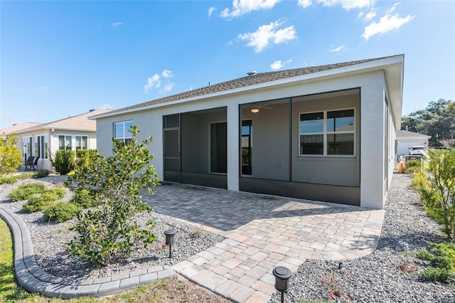 back of property featuring ceiling fan, a patio, and stucco siding