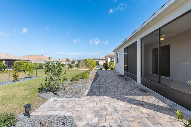 view of yard featuring a residential view and a patio