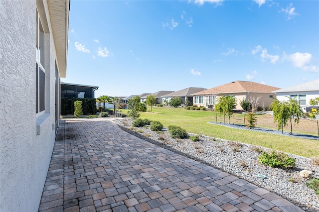 view of patio featuring a residential view and decorative driveway