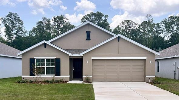 2889 NE 21st Terrace Rd, Ocala, FL 34470 - ranch-style house featuring driveway, stucco siding, a garage, and a front yard