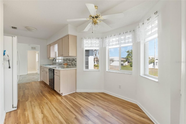 kitchen featuring visible vents, light wood-style floors, light countertops, decorative backsplash, and dishwasher