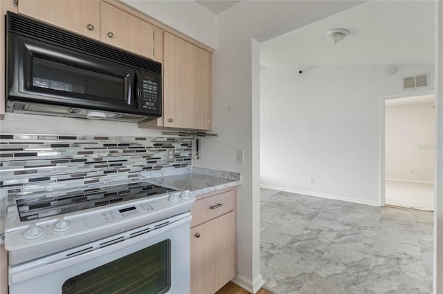 kitchen with electric stove, light countertops, visible vents, light brown cabinets, and black microwave