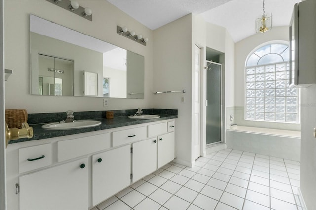 full bath with double vanity, a shower stall, a sink, and tile patterned floors