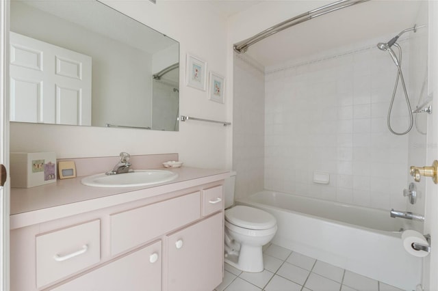 bathroom featuring tile patterned flooring, tub / shower combination, vanity, and toilet