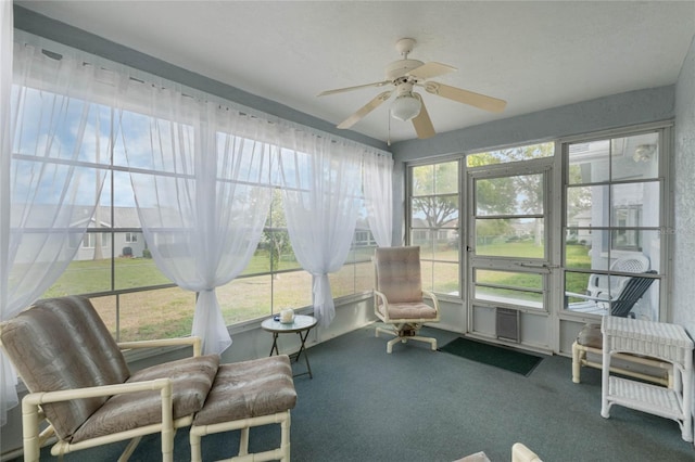 sunroom featuring a ceiling fan