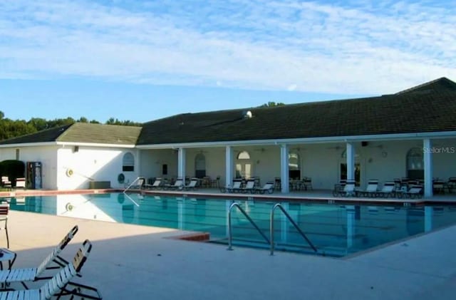 community pool with a patio area