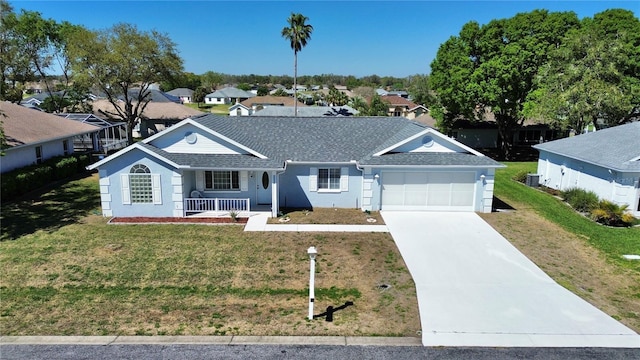 ranch-style home featuring a front lawn, a garage, covered porch, and driveway