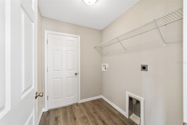 clothes washing area with laundry area, washer hookup, wood finished floors, baseboards, and electric dryer hookup