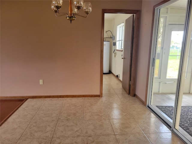 spare room featuring gas water heater, baseboards, and an inviting chandelier