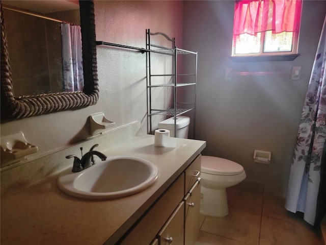 bathroom with toilet, a shower with curtain, tile patterned flooring, and vanity