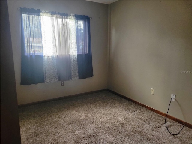 spare room featuring baseboards