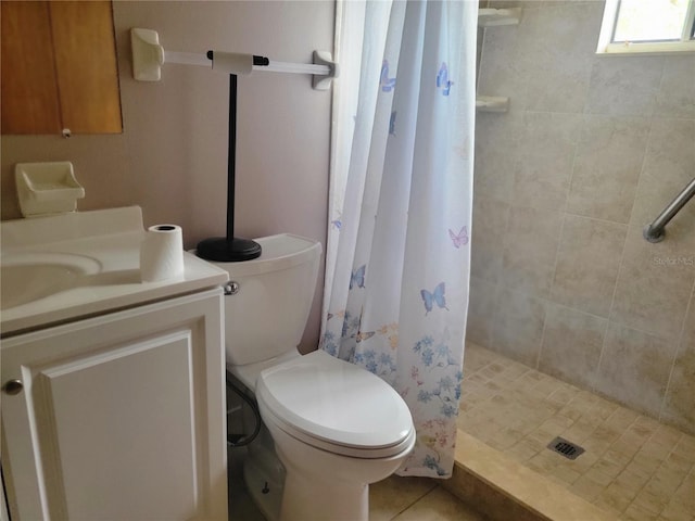 bathroom featuring toilet, a shower stall, and vanity