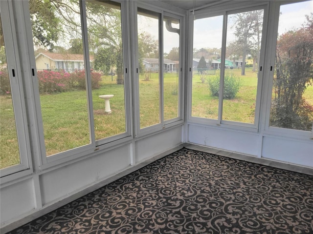 unfurnished sunroom featuring a residential view