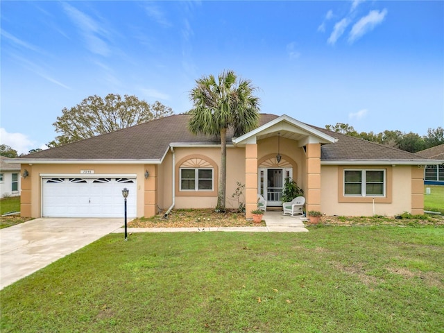 single story home featuring a garage, a front yard, concrete driveway, and stucco siding