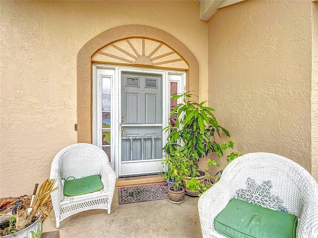 doorway to property with stucco siding