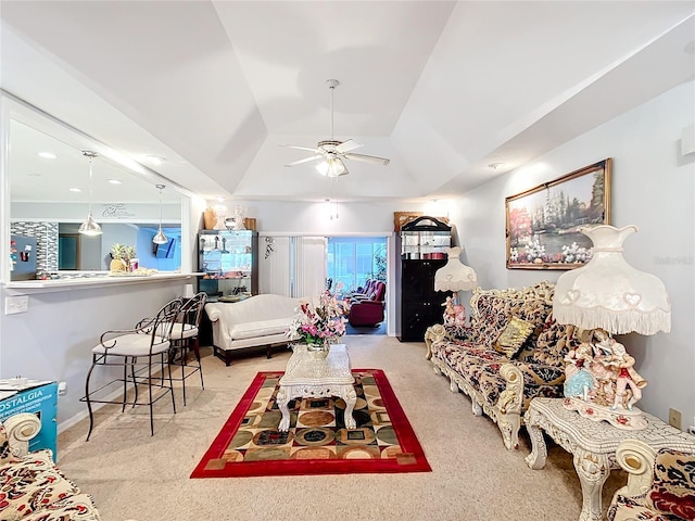 carpeted living room featuring vaulted ceiling and a ceiling fan