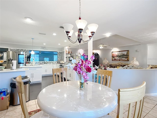 dining space with light tile patterned floors, ceiling fan with notable chandelier, visible vents, and recessed lighting