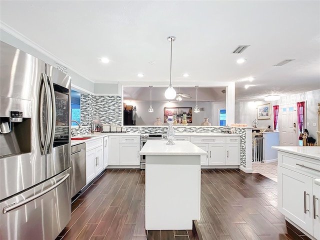 kitchen with visible vents, stainless steel appliances, backsplash, and light countertops