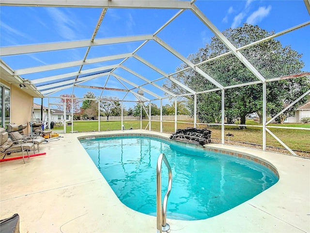 outdoor pool featuring a patio area, glass enclosure, and a yard