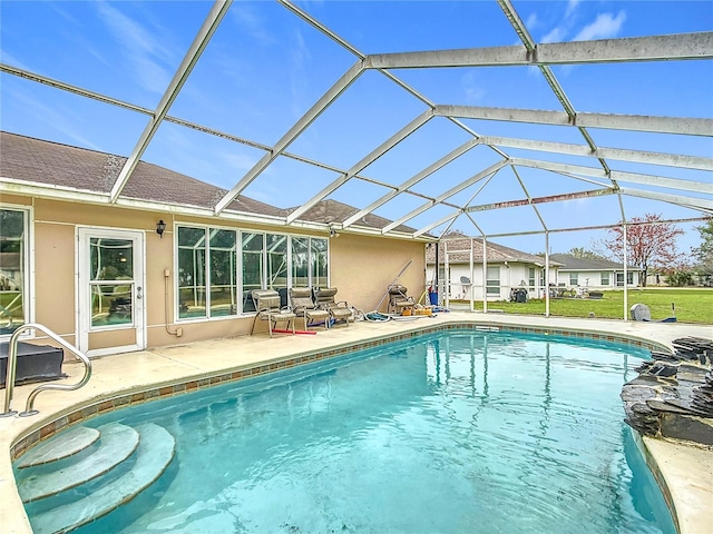 pool featuring a lanai, a yard, and a patio