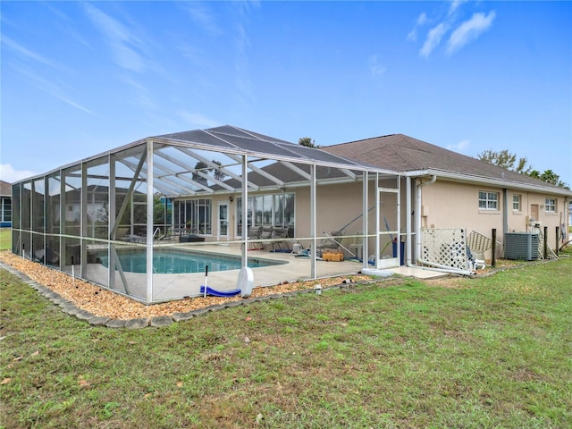 rear view of property featuring stucco siding, a lawn, a patio area, cooling unit, and an outdoor pool